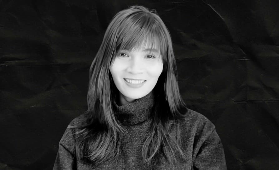 Vanielle Lee smiling in a dark turtleneck